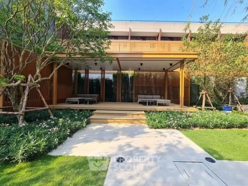 Luxurious garden view with modern wooden terrace and lush greenery
