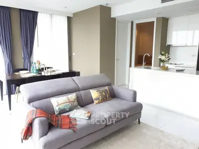 Modern living room with cozy sofa and elegant dining area in open layout apartment.