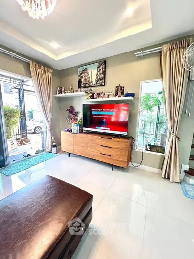 Spacious living room with modern decor and large windows for natural light