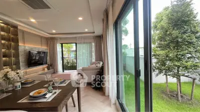 Modern living room with garden view and elegant dining setup