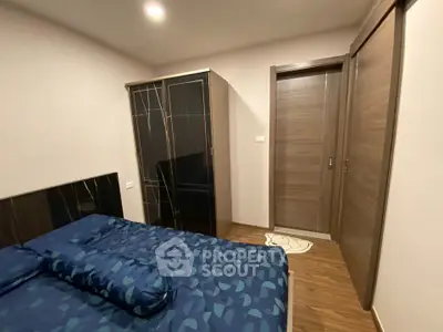 Cozy bedroom with modern wardrobe and stylish bedding in a contemporary apartment.