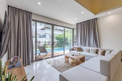 Spacious modern living room with pool view, large sectional sofa, and elegant decor.