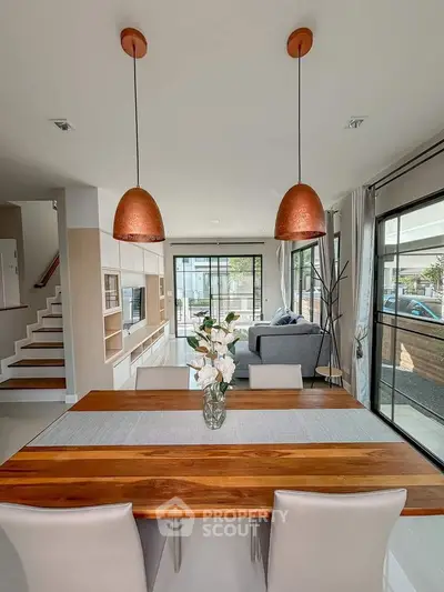 Modern open-plan living and dining area with stylish decor and natural light