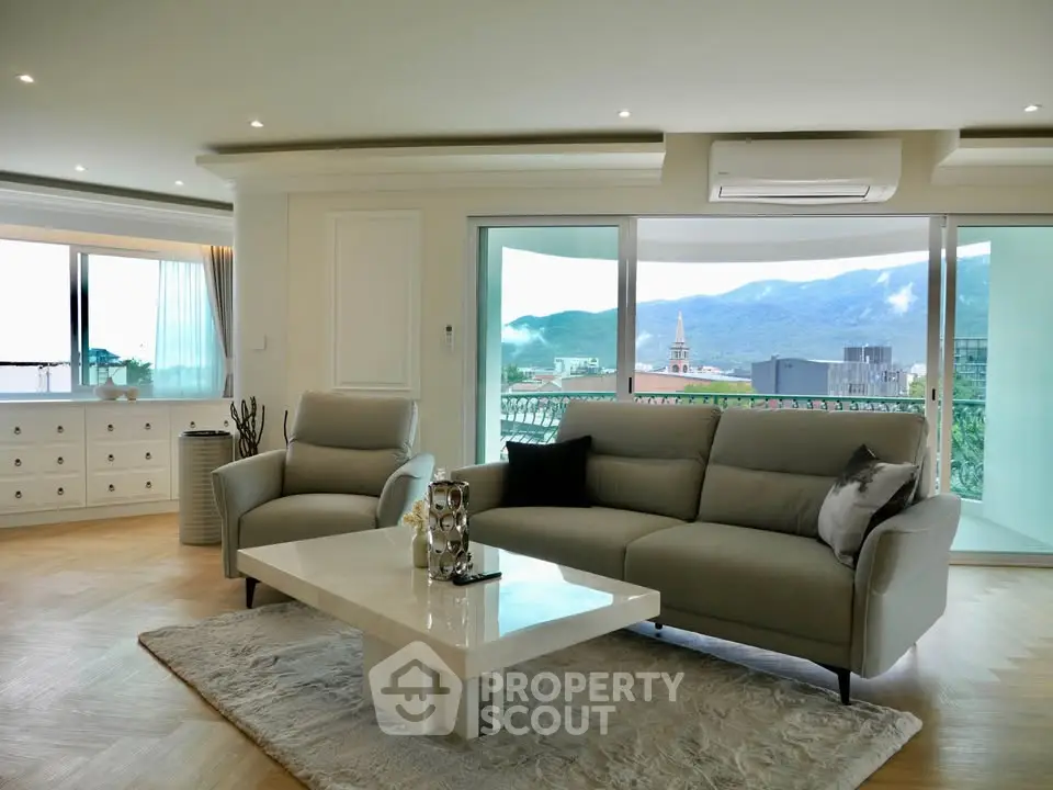 Luxurious living room with stunning mountain view and elegant furnishings.