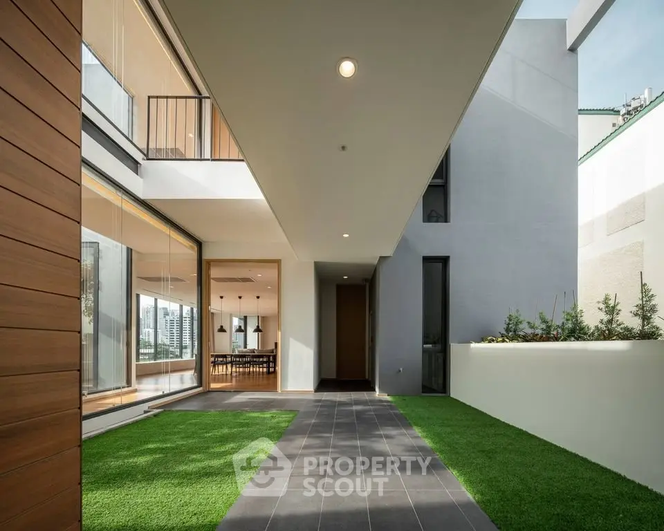 Modern architectural exterior with sleek design and lush green landscaping.