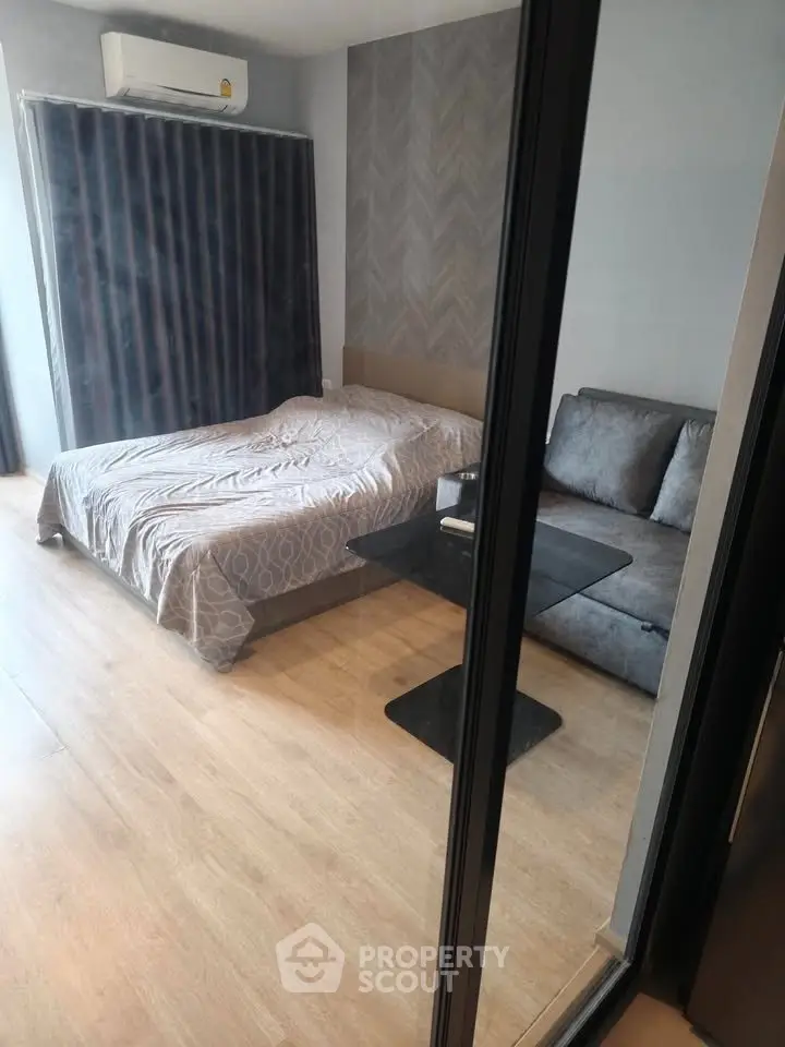 Modern bedroom with cozy bed and stylish sofa in a chic apartment