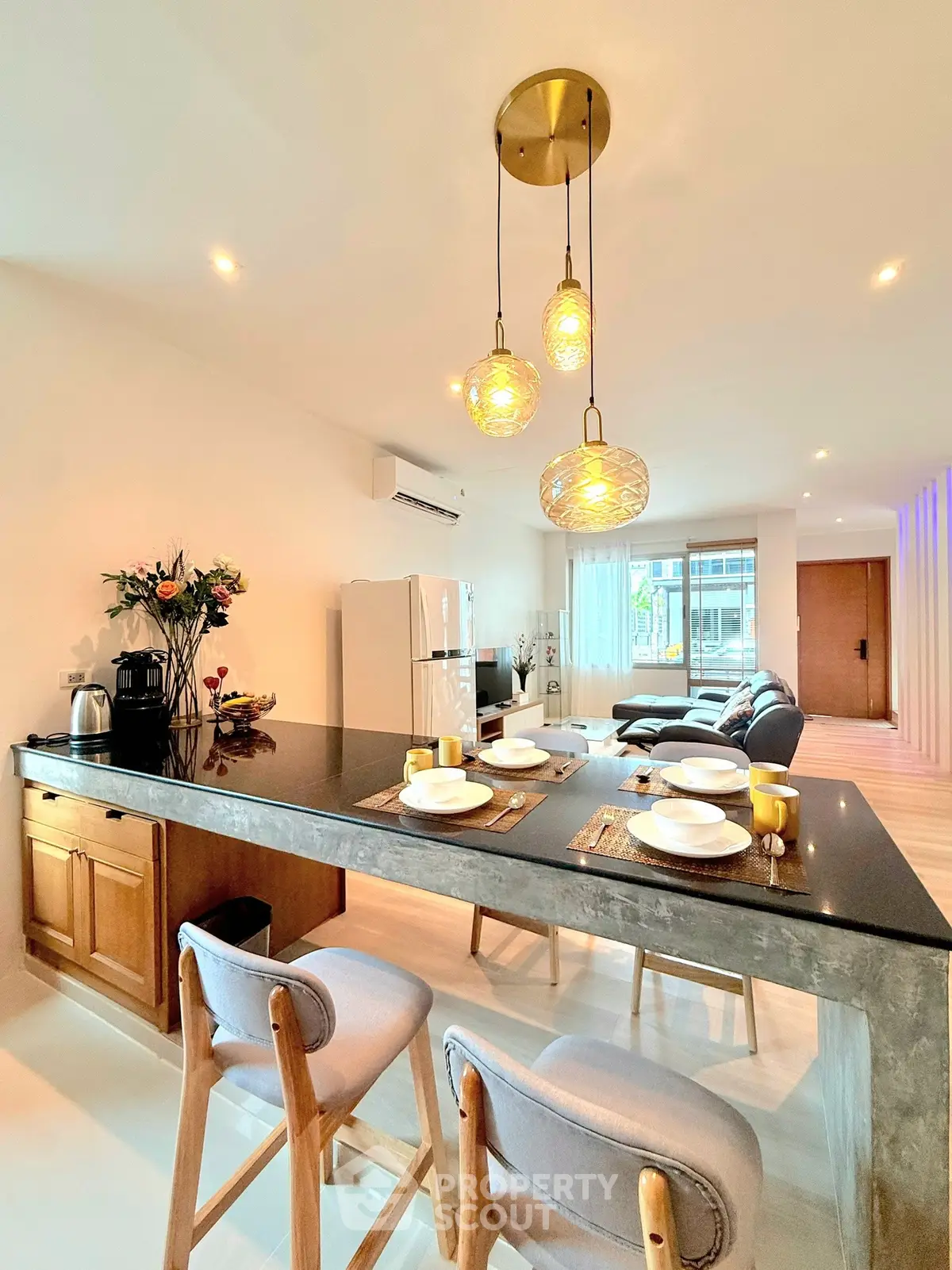 Spacious open-plan kitchen and living room with modern decor and ample natural light.