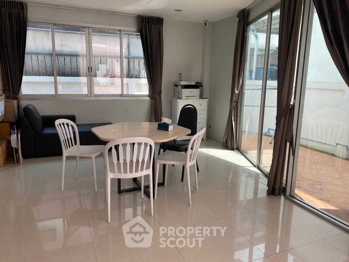 Spacious living room with large windows and modern furniture, perfect for natural light lovers.