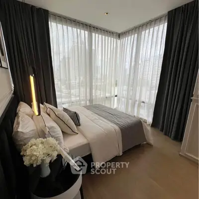 Luxurious corner bedroom with floor-to-ceiling windows and city view