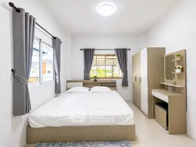 Modern bedroom with stylish furniture and large windows for natural light