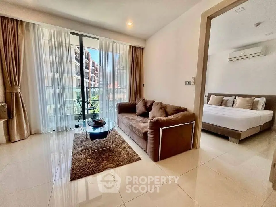Modern living room with balcony view and adjacent bedroom in luxury apartment