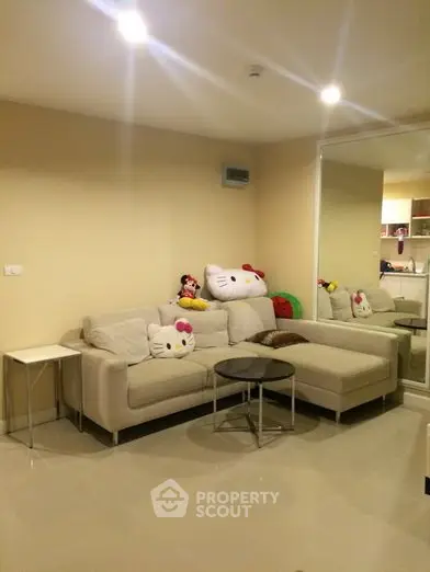 Modern living room with cozy beige sofa and stylish decor in a contemporary apartment.