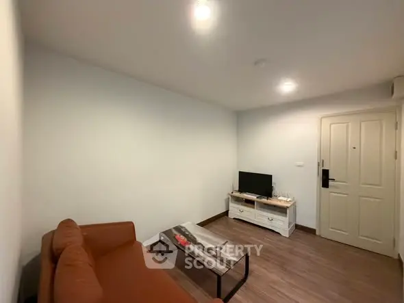 Cozy living room with modern furniture and warm lighting, perfect for relaxation.