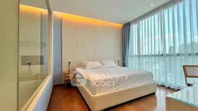 Spacious modern bedroom with large windows and elegant decor