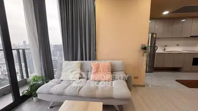 Modern living room with city view and stylish kitchen