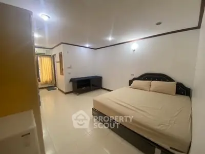 Spacious bedroom with modern furnishings and ample natural light