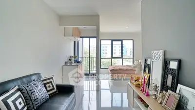 Modern studio apartment with open layout and large windows for natural light.