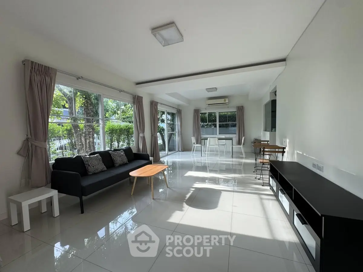 Spacious modern living room with large windows and stylish furniture