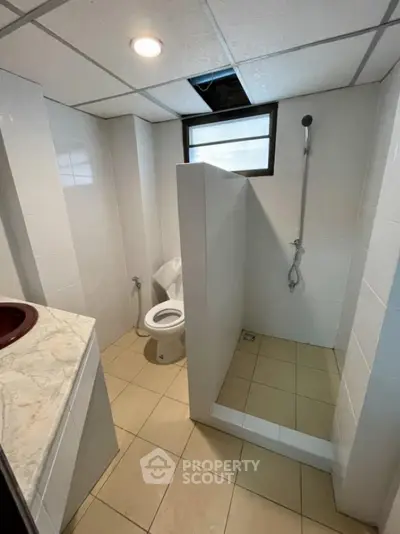 Modern bathroom with walk-in shower and sleek fixtures, perfect for contemporary living.