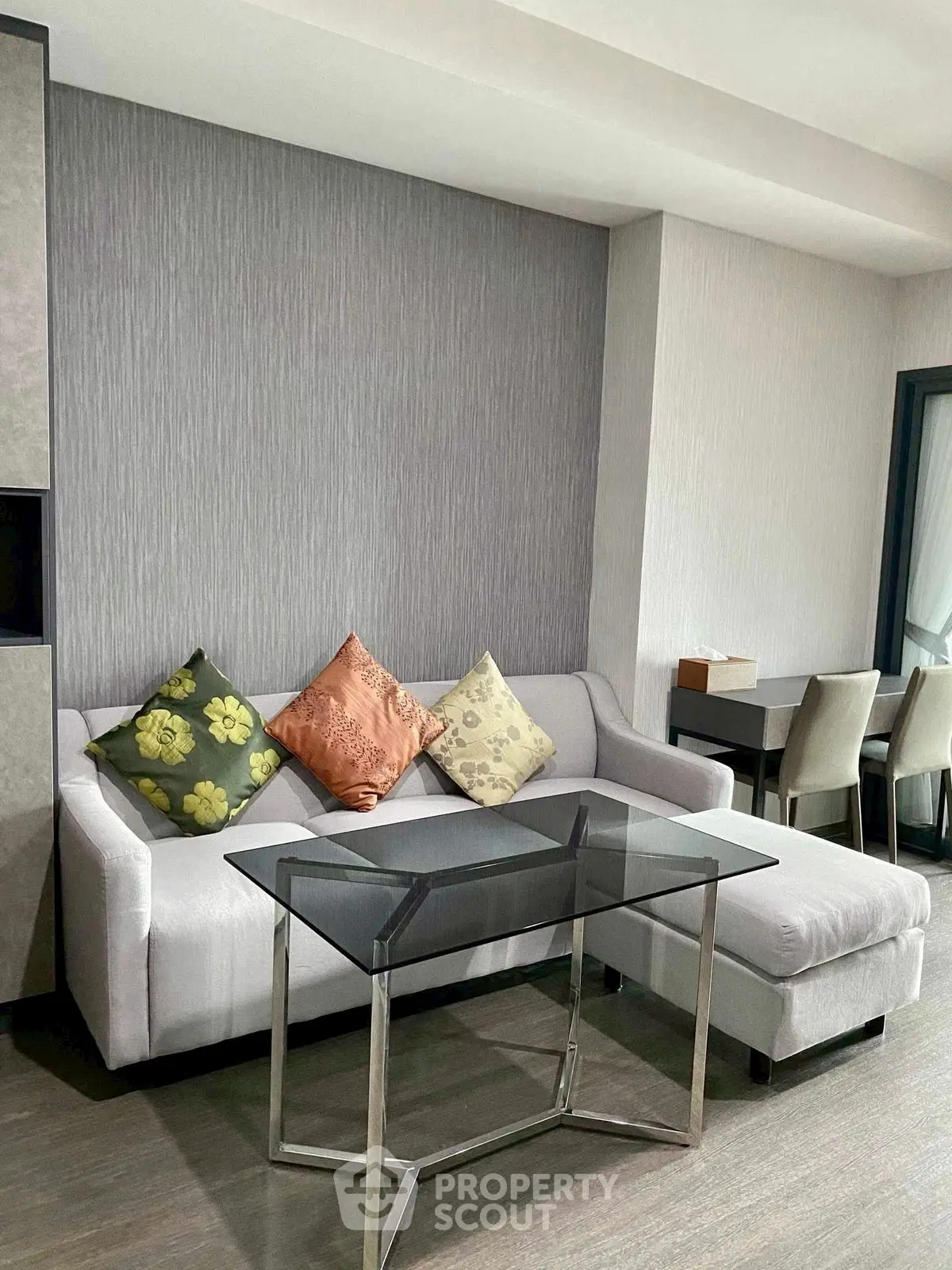 Modern living room with stylish sofa and glass coffee table in a contemporary apartment.