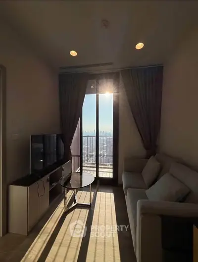 Charming living room with balcony view and natural sunlight