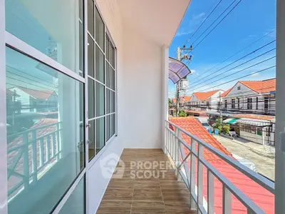 Spacious balcony with scenic neighborhood view and modern design.