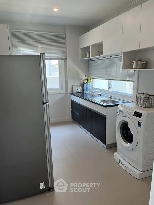 Modern kitchen with sleek appliances and ample natural light