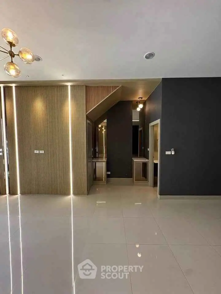 Modern interior with sleek lighting and glossy tile flooring in a contemporary living space.