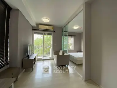 Modern living room with large windows and balcony access in a stylish apartment