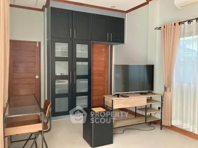 Modern living room with sleek black cabinetry and stylish TV stand