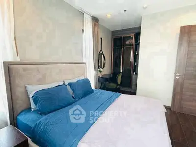 Modern bedroom with stylish decor and cozy blue bedding