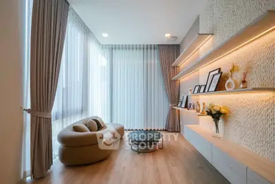 Elegant living room with modern decor, large windows, and stylish furniture