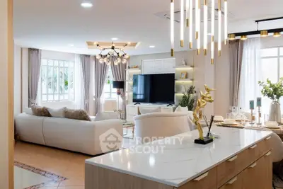Luxurious open-plan living room with elegant decor and modern lighting