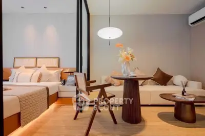 Modern bedroom with stylish decor, cozy seating area, and elegant lighting in a luxurious apartment.