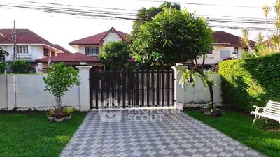 Charming suburban home with gated driveway and lush garden, perfect for family living.