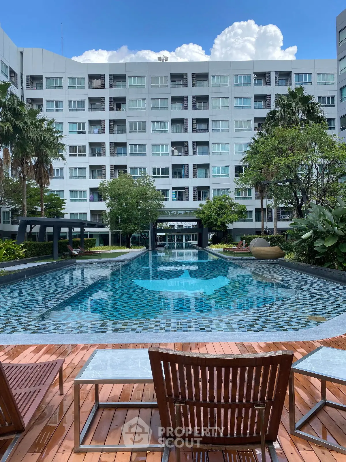 Luxurious condominium with stunning pool and lush garden views, perfect for relaxation and leisure.