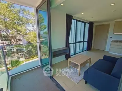 Modern living room with floor-to-ceiling windows and balcony view