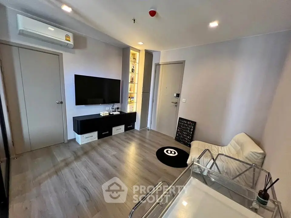Modern living room with sleek design and wall-mounted TV in a stylish apartment.