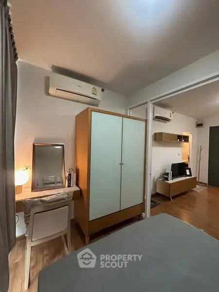 Cozy bedroom with modern furniture and air conditioning in a stylish apartment.
