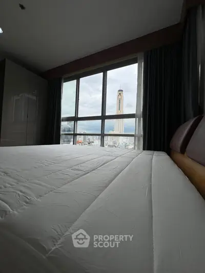 Spacious bedroom with stunning city view through large windows