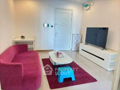 Modern living room with vibrant pink sofa and sleek TV setup
