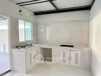 Modern kitchen with sleek design and gas stove, perfect for culinary enthusiasts.