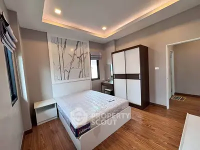 Modern bedroom with stylish decor and ample natural light