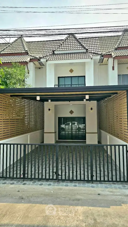 Charming townhouse with gated entrance and modern facade in a serene neighborhood.