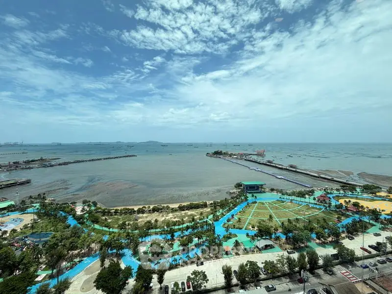Stunning ocean view from high-rise building with lush green park below, perfect for serene living.