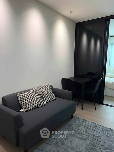 Modern living room with sleek sofa and dining area in stylish apartment