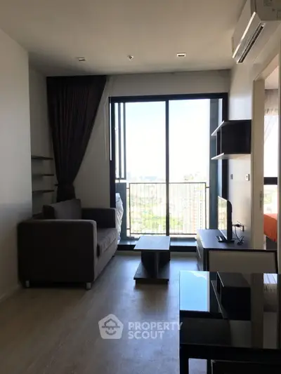 Modern living room with balcony view in high-rise apartment
