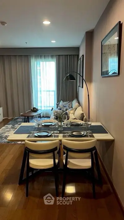 Modern living room with dining area, stylish decor, and natural light, perfect for urban living.