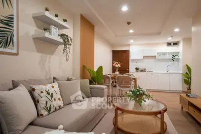 Charming open-plan living room with cozy seating and modern kitchen.