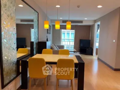 Modern living room with yellow chairs and stylish lighting in urban apartment